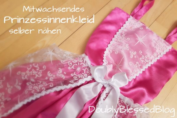 Selbstgenähtes Prinzessinnenkleid mit Unterrock und Oberteil in pink und durchscheinendem Überrock und Dekoelement auf dem Oberteil in weiss.